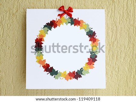 Autumn card with circle of colorful paper leaves