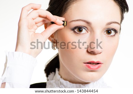 Woman using micro memory card plugging into head concept closeup portrait on white background