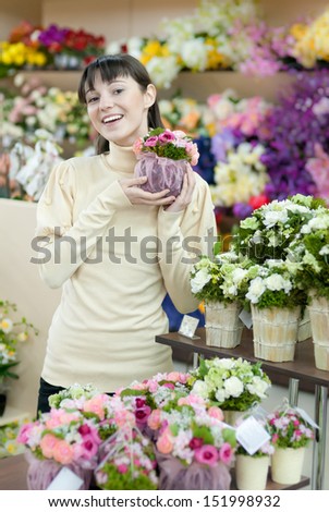 Young beautiful happy smiling female lady woman working in flower shop & presenting flowers