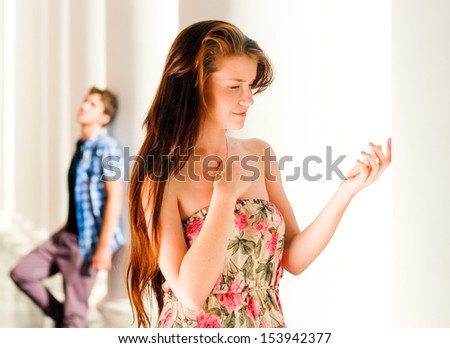 Young couple man & woman in relationship looking to different directions, offended or sad