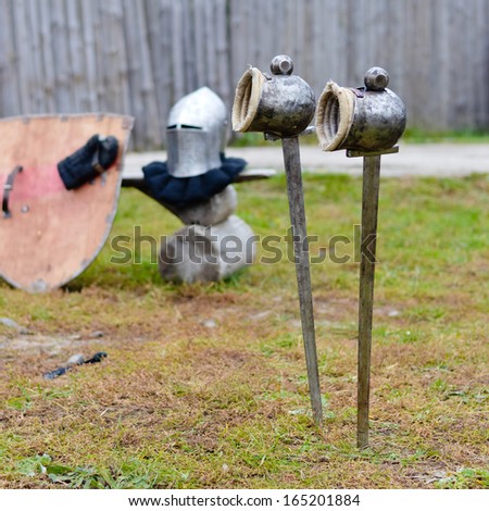 Two swords with gloves waiting in ground before festival knight battle