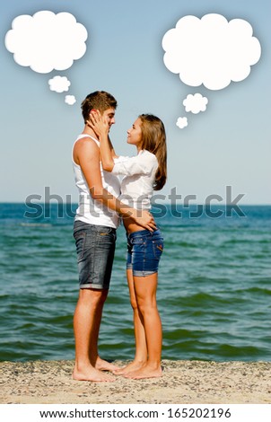 Young happy romantic couple at sea coast with dialog box above them