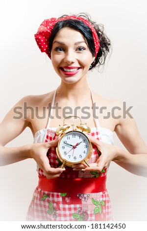 young beautiful funny pinup young woman attractive girl with big smile holding alarm clock looking at camera background