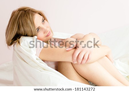 sensitive young attractive sweet girl sits embraced feet and dreaming looking up