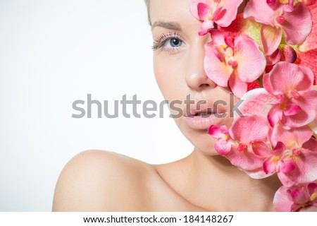 Beautiful girl face & pink flowers, perfect skin and lips on white copyspace on white background closeup portrait