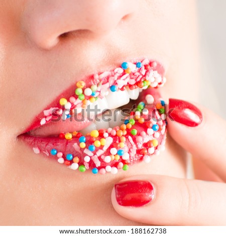 Seductive plump lips sprinkled with sweet crumbs closeup