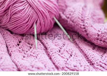 clew and pink woven texture fabric hand made knitting sweater, cardigan or shawl detail design copy space background close up image