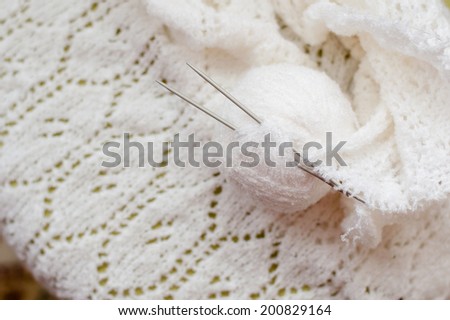 clew and white woven hand made knitting sweater, cardigan or shawl detail design texture fabric copy space background close up image
