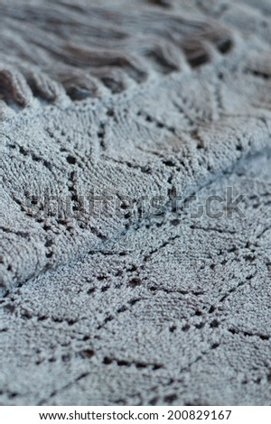 close up picture of gray design texture woven hand made knitting sweater, cardigan or shawl detail fabric copy space background