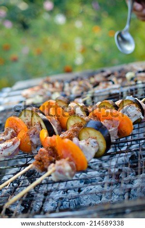 Grilled meat with tomato and aubergine on wooden sticks