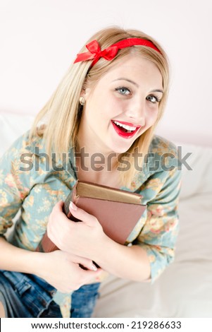 reading book beautiful blonde pinup young woman girl with red lipstick looking at camera
