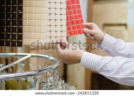 hands of choosing buyer or employee presenting colorful samples, closeup picture