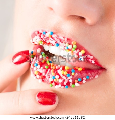 closeup on seductive plump lips sprinkled with sweet crumbs