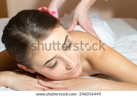 closeup image on tired pretty woman lying on a table and taking beauty massages procedure