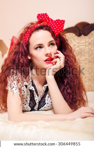 Sad red head lady  with beautiful long wavy hair in  polka dot band