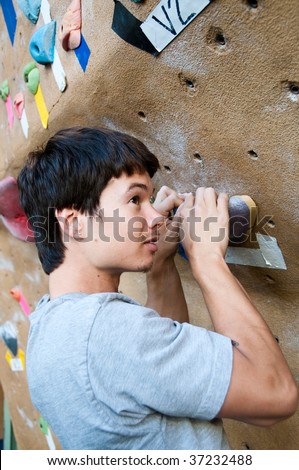 a young climber in a climbing gym