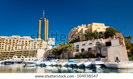 Fantastic city landscape on the seaside with boats. Portomaso Business Tower, Malta.
