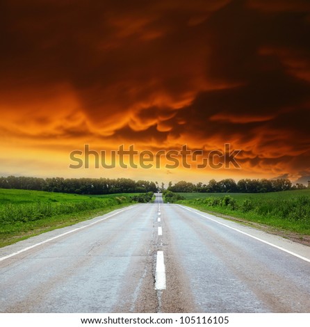 Empty asphalt road with cloudy sky and sunlight