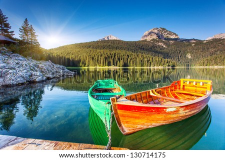 Reflection In Water Of Mountain Lakes And Boats. Black Lake In Durmitor National Park In Montenegro, Europe. Beauty World.