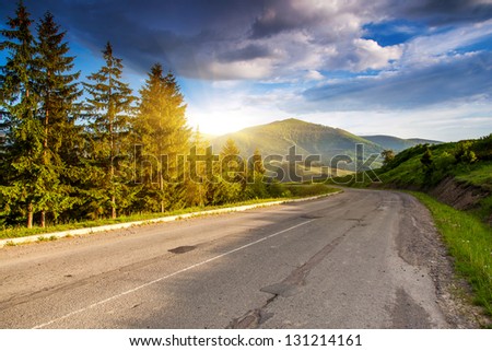 Empty Asphalt Road With Cloudy Sky And Sunlight