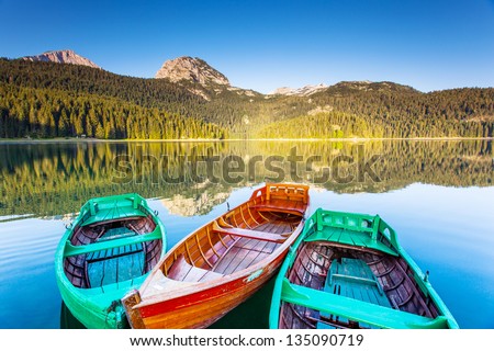 Reflection In Water Of Mountain Lakes And Boats. Black Lake In Durmitor National Park In Montenegro, Europe. Beauty World.