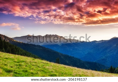 Mountains glow by sunlight. Morning overcast sky. Dramatic scenery. Carpathian, Ukraine, Europe. Beauty world.