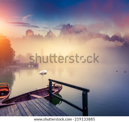 Majestic colorful scenery on the foggy lake in Triglav national park, located in the Bohinj Valley of the Julian Alps. Dramatic view. Instagram effect, retro filter. Slovenia, Europe. Beauty world.