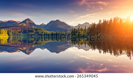 Fantastic mountain lake in National Park High Tatra. Dramatic scenery. Strbske pleso, Slovakia, Europe. Beauty world. Soft filtered and vintage effect. Instagram toning. Double exposure effect.