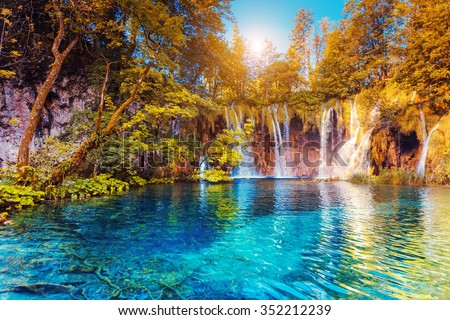 Majestic view on turquoise water and sunny beams.  Location famous resort Plitvice Lakes National Park, Croatia, Europe. Dramatic and vivid scene. Beauty world. Retro filter. Instagram toning effect.