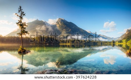 View on turquoise water and scene of trees on a rock island at Lake Hintersee. Location famous resort National park Berchtesgadener Land, Ramsau, Bavaria, Alps. Europe. Artistic picture. Beauty world.