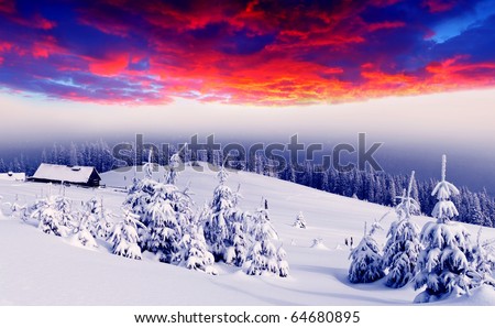 Majestic sunset in the winter mountains landscape. Mountain house