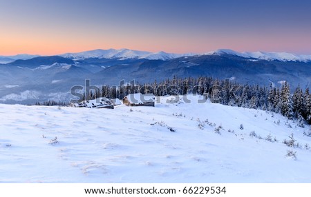 Sunrise in the mountains in winter on a cold morning. Mountain house