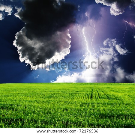 Thunderstorm with lightning in green meadow. Dramatic sky.