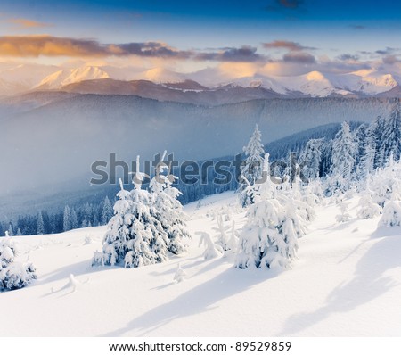 Majestic sunset in the winter mountains landscape. Dramatic sky.