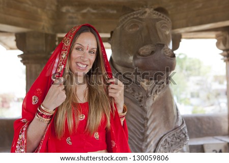 Woman in red sari at Khajuraho Temple. India.