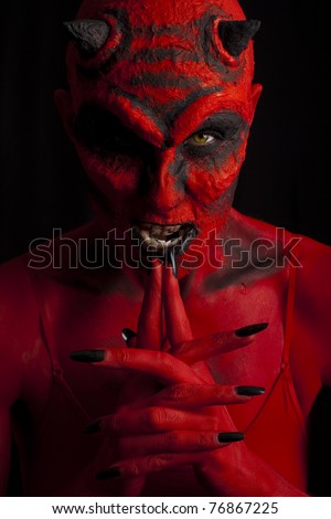 Scary red devil woman. Low key lighting.