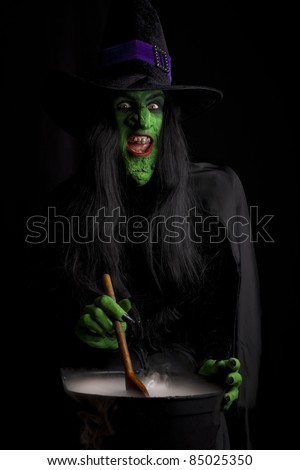 Evil witch stirring her misty cauldron, black background.