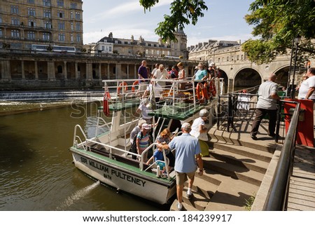 BATH, UK - SEPTEMBER 5: Sightseers in the City of Bath enjoying the warm weather disembark from a River Avon tour boat on September 5, 2013 in Bath, UK.