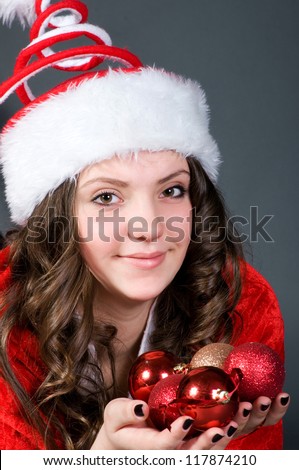 The cute girl with Christmas cap and balls