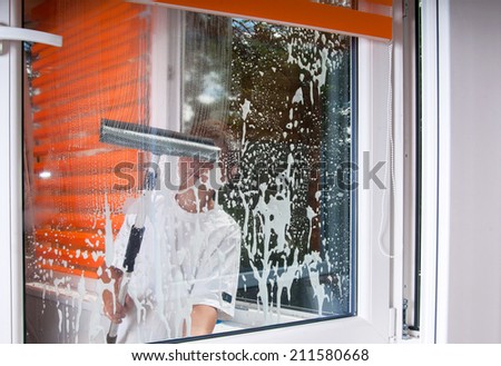 The boy cleans the window