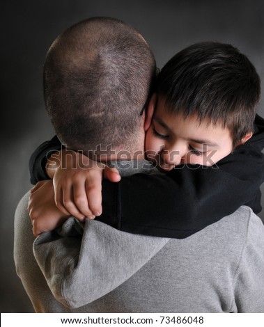 dad hugging his son