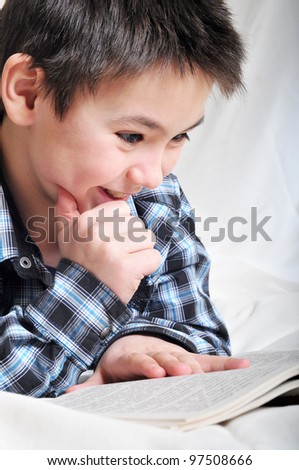The boy reads a fun book
