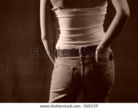 woman from behind wearing tight jeans with hand in pocket