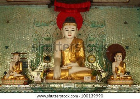 Main Buddha statue between second buddha praying Myanmar style