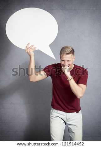 Stressed worried man biting his hand in frustration while holding white empty speech balloon with space for text isolated on white background.