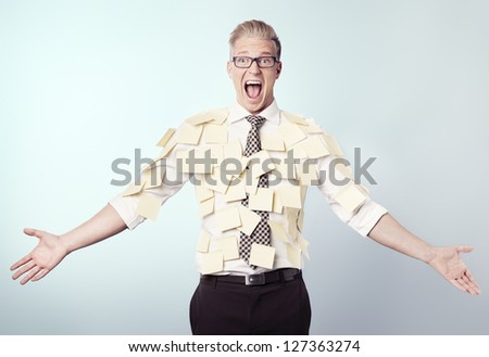 Overburdened shouting businessman covered by many empty yellow stickers with space for text, isolated.