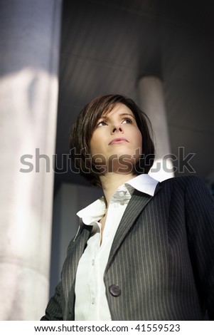 Young confident business woman looking ahead, serious look