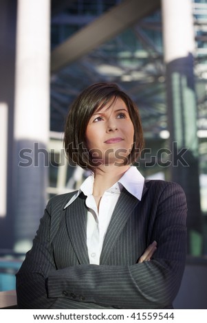 Young confident business woman looking ahead, friendly look