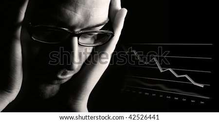 Close-up of thoughtful male professional being worried about poor business outlook, low-key black & white image.