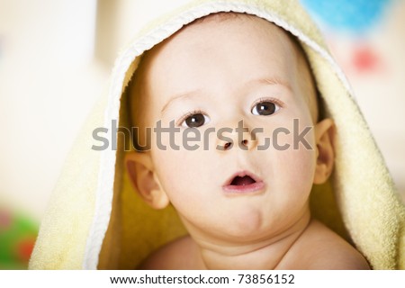 stock photo Close up portrait of sweet naked baby boy with yellow towel on
